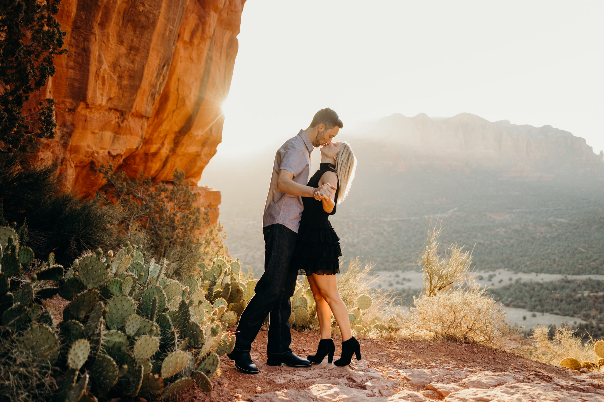 man kisses woman on cathedral rock